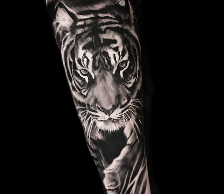 Realistic tiger and baby tiger tattoo on the forearm.