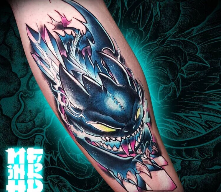 Toothless tattoo located on the upper arm