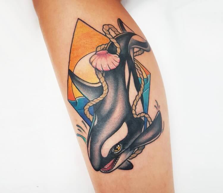 Killer whale tattoo on the left forearm.