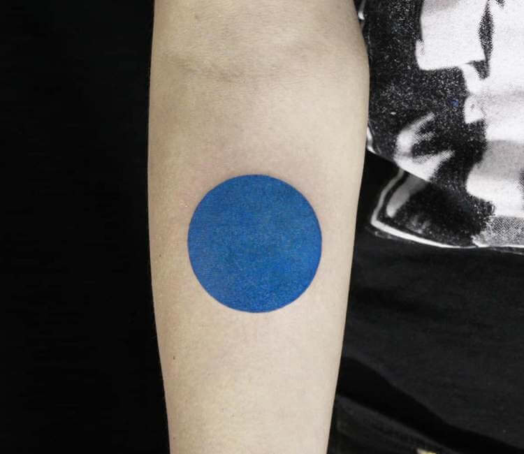 Hand poked minimalist circle tattoo on the left inner