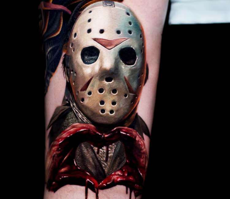 Realistic Jason Voorhees tattoo on the right upper arm