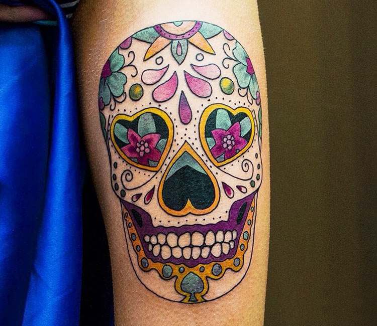 Illustrative sugar skull tattoo on the right inner