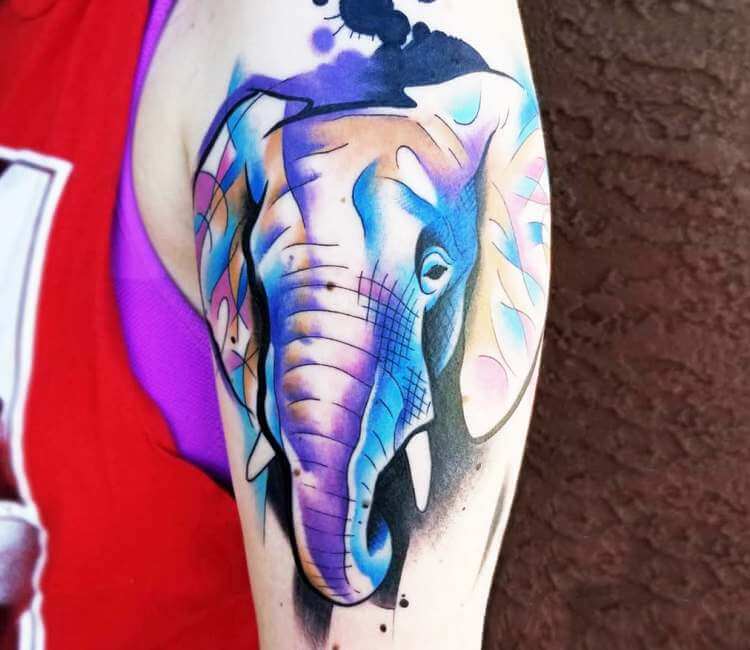Watercolor elephant tattoo on the upper back.
