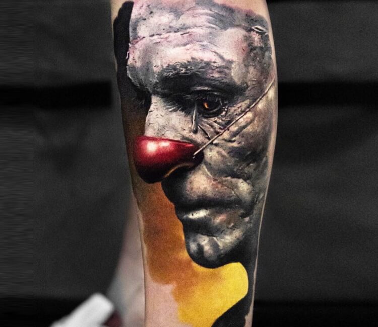 Traditional style sad clown tattoo located on the upper