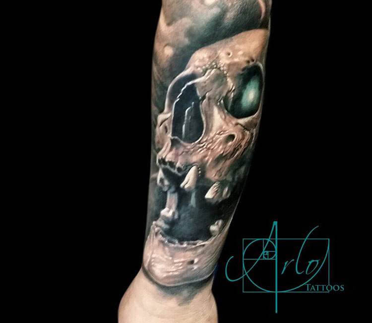 Sugar skull tattoo on the left forearm.