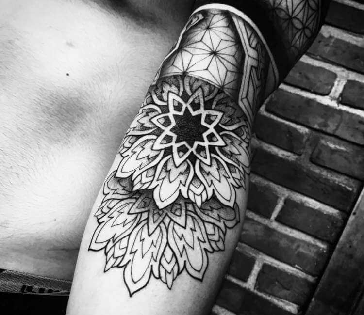 Black simple mandala on the arm - Tattoogrid.net