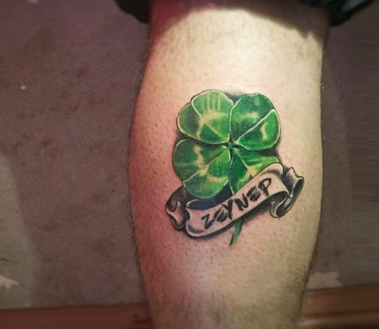Minimalistic four leaf clover tattoo placed on the