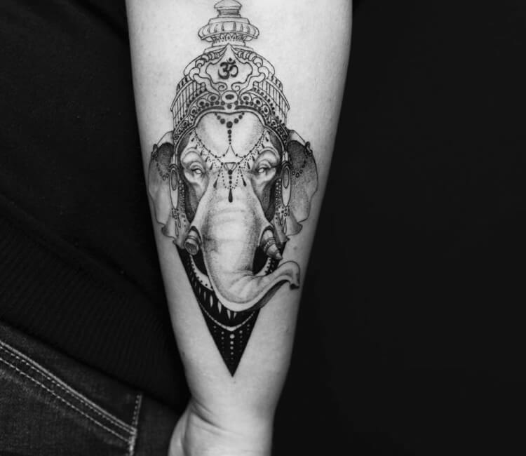 This Ganesh tattoo shows the god with only two arms. | Ratta Tattoo
