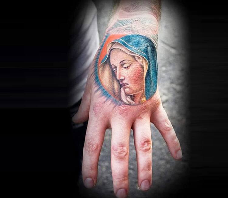 Minimalist Virgin Mary tattoo on the wrist