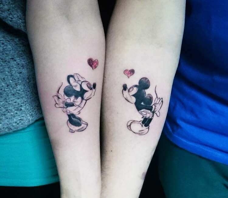 Mickey Mouse tattoo on the wrist.