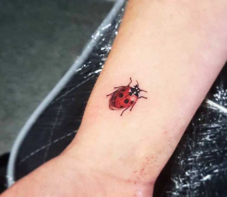 Little ladybug tattoo on the wrist