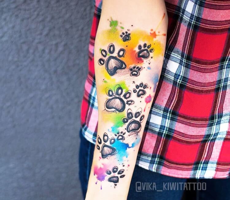 Watercolor dog paw tattoo on the wrist