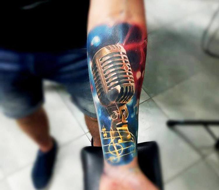 Microphone tattoo on the left inner forearm.