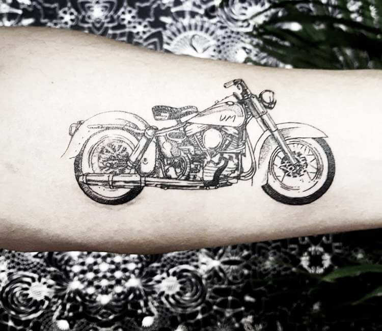 Motorcycle tattoo located on the thigh.