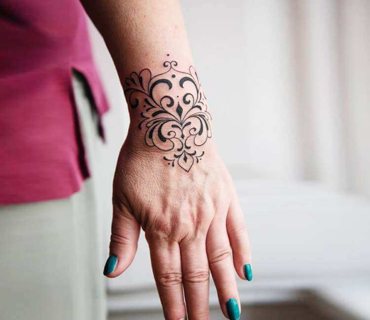 Flower black ornament tattoo on the wrist  Tattoogridnet