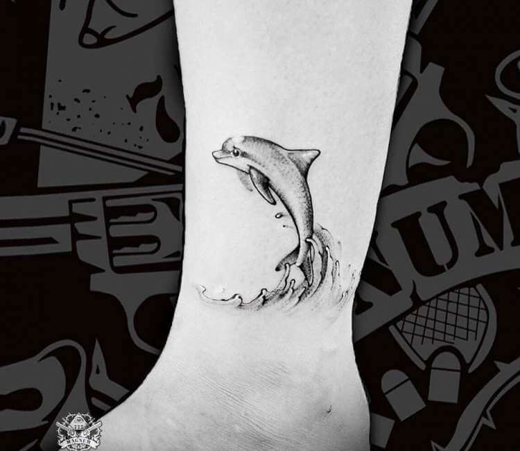 Dolphin tattoo on blue wall with water reflections: Graphic #11798165
