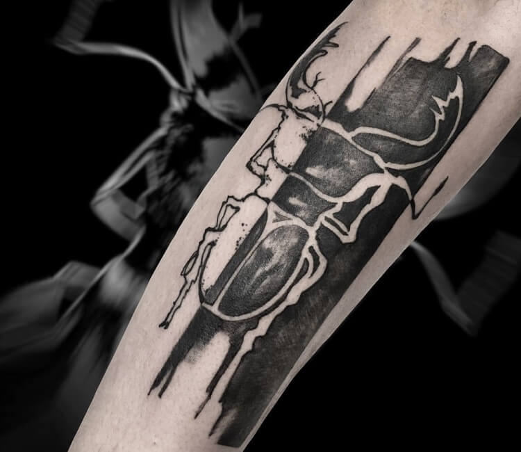Kintsugi scarab tattoo located on the upper back,