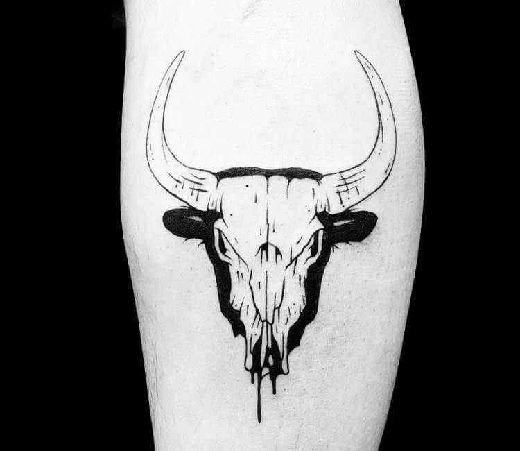 Fine line bull skull tattoo located on the tricep.