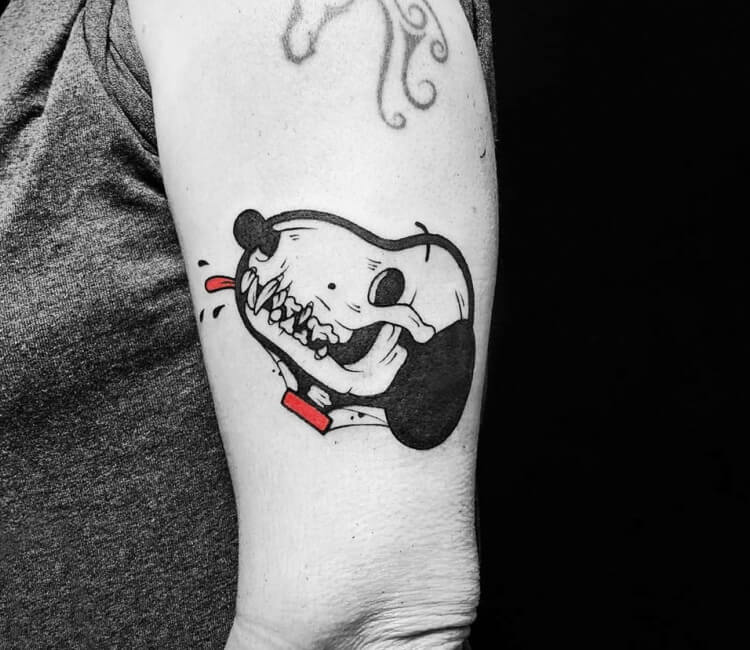 Fine line snoopy tattoo on the back of the left arm