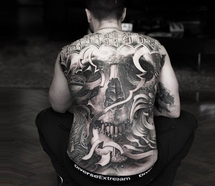 Huge black and grey skull backpiece tattoo