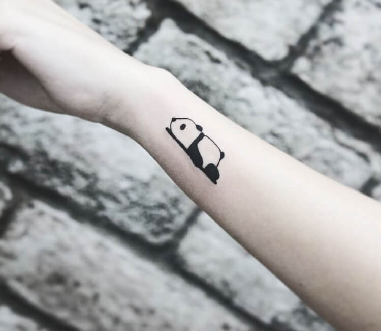 Tiny panda bear tattoo on the inner wrist